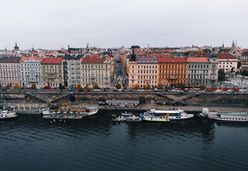 Fototapeta premium Beautiful aerial view of Prague city in Czech republic with Vltava river and old town in autumn time - taken by drone. Cityscape of Prague from above.