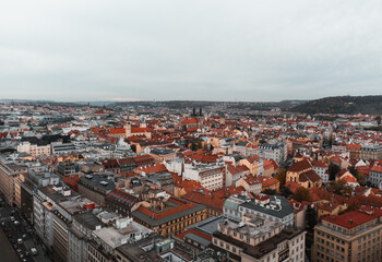 Naklejka na ściany i meble Beautiful aerial view of Prague city in Czech republic - historical part and old town in autumn time - taken by drone. Cityscape of Prague from above at evening - dark moody weather.