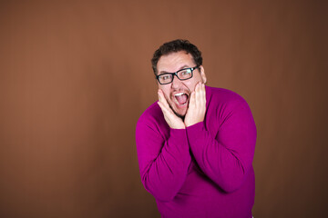 Funny fat man posing in studio on brown background. Different emotions.