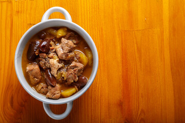 Lamb stewed with potatoes in spices and sauce in a soup plate on the table. copy space