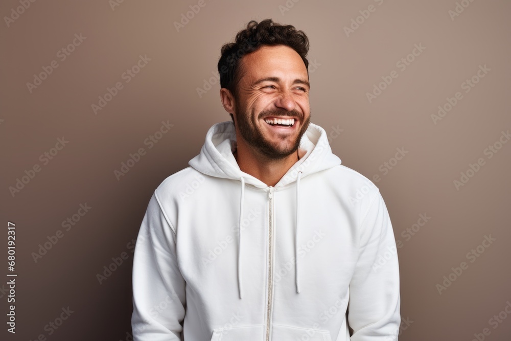 Sticker portrait of a grinning man in his 30s wearing a zip-up fleece hoodie against a pastel gray backgroun