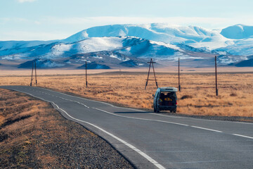 Pickup truck. Mountain long Mongolian road, a lonely car stopping on the side of the road, the...