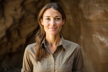 Portrait of a content woman in her 30s sporting a breathable hiking shirt against a soft brown background. AI Generation