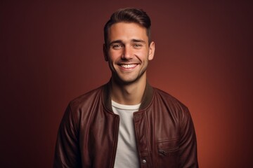 Obraz premium Portrait of a grinning man in his 30s wearing a trendy bomber jacket against a soft brown background. AI Generation