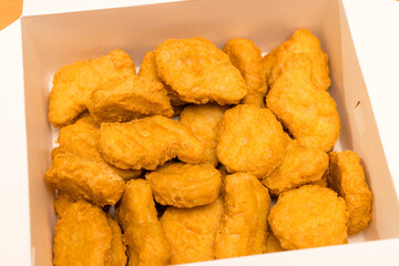 Golden deep fired chicken nugget in paper box