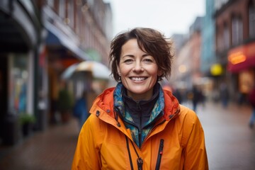 Fototapeta premium Portrait of a cheerful woman in her 40s dressed in a water-resistant gilet against a vibrant market street background. AI Generation