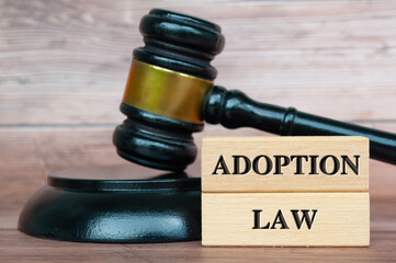 Adoption Law text engraved on wooden blocks.