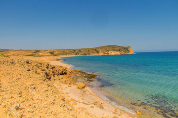 Fototapeta na wymiar Rocky Beach with Ocean and Mountain Views at Cap Fartas, Korbous, Tunisia
