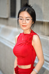 High-quality, free stock photo A fashionable Asian Vietnamese girl wearing a red dress is walking down the street, representing the energetic youth. Advertisements for products