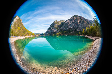 Fisheye view of turquoise colored Lake Braies in Italy's dolomite mountains