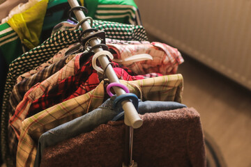 Clothes on hangers in a home. Second hand for swap. Concept of sustainable lifestyle and smart...