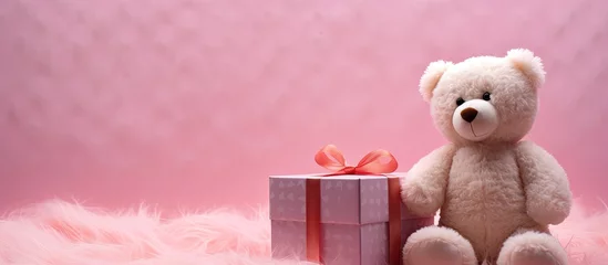 Fototapeten In an isolated corner of a room, a heart-shaped gift box rests on a white tablecloth. Inside, a cute pink bear toy with soft fur peeks out, invoking memories of childhood fun and love. The white © AkuAku