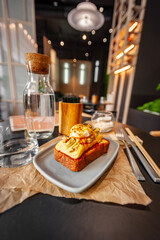 Croque Madame hot french sandwich with ham, melted cheese, fried egg and sauce.