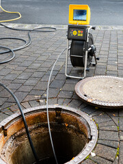 A drain cleaning company checks a blocked drain with a camera before flushing it out - obrazy, fototapety, plakaty