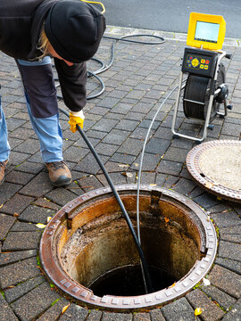 A drain cleaning company checks a blocked drain with a camera before flushing it out