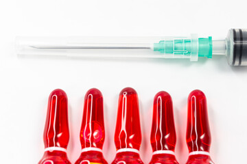 B12 hormone injection ampoules in selective focus. Ampoules and syringes containing solution for...