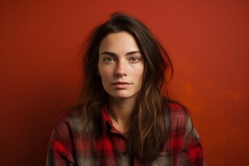 Portrait of a tender woman in her 20s wearing a comfy flannel shirt against a solid color backdrop. AI Generation