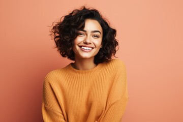 Fototapeta premium Portrait of a jovial woman in her 20s wearing a cozy sweater against a solid color backdrop. AI Generation