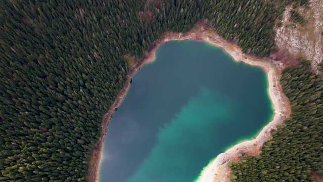 Aerial view of reflection clouds and sunlight on Black Lake located in Durmitor National Park region of Montenegro