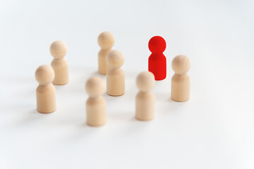 People stand in a circle on a white background. Communication. Business team, teamwork, team spirit. Wooden figures of people. A circle of people. discussion, cooperation, cooperation. Selective focus