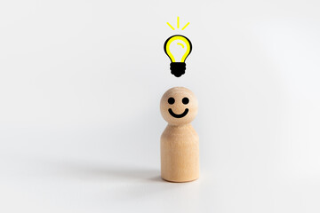 Wooden doll Man standing with light bulb icon idea, intelligent think power, creative and idea concept.