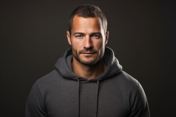Obraz premium Portrait of a glad man in his 30s wearing a thermal fleece pullover against a light wood minimalistic setup. AI Generation