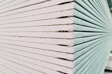 Drywall stacked in stacks at a hardware store, close up.