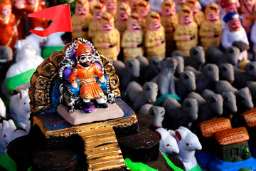 Pune, India, In Maharashtra children build mud forts as an homage to Chhatrapati Shivaji Maharaja, and decorate it with small warrior statues made of soil, which are sold in the market before Diwali.