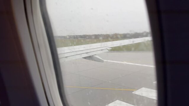 View from airplane taxiing in Modlin airport in Poland in November on rainy day