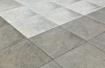 Gray and white stoneware tiles, natural stone effect. Outdoor pavers. Background and texture.