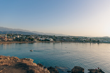 Fototapeta premium Cityscape at sunset, Agioi Apostoli, Chania, Crete, Greece.