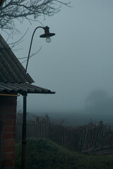old street lamp in the fog in an abandoned village