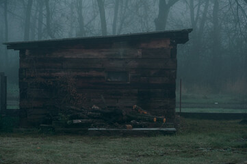 Old barn in the fog in an abandoned village