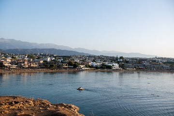 Fototapeta premium Cityscape at sunset, Agioi Apostoli, Chania, Crete, Greece.