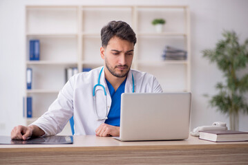 Young male doctor in telemedicine concept