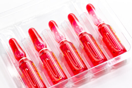 Injection ampoules of hormone B12 in selective focus. Ampoules containing solution for injection used for supplementation of vitamin B12 contain Cyanocobalamin.