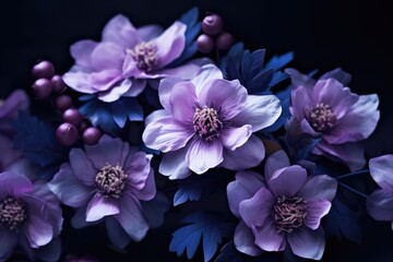  a bunch of purple flowers sitting on top of a black table next to a blue and purple flower vase on top of a table.