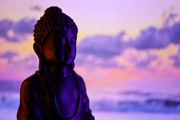 Buddha Purnima and Vesak day concept, Buddha statue with low key light against beautiful and...