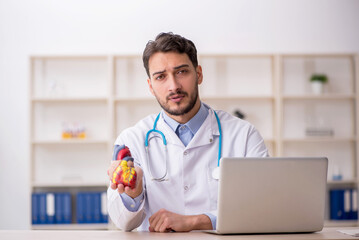 Young male doctor cardiologist working in the clinic