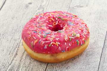 Sweet glazed struwberry donut with icing