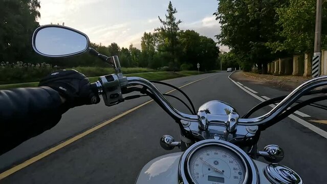 Fast riding a motorcycle around the city at sunset, time lapse