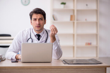 Young male doctor in telemedicine concept