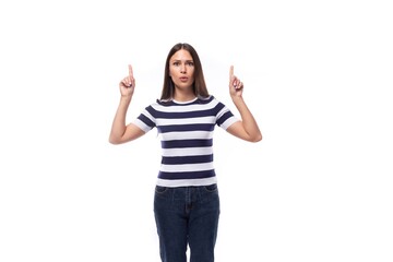 young brunette caucasian woman with light makeup dressed in a striped t-shirt and jeans works in advertising and gesticulates with her hands