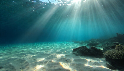 underwater background deep blue sea and beautiful light rays with sandy floor - obrazy, fototapety, plakaty