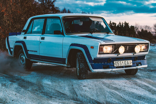 Harju County, near Tallinn, Estonia - November 18th 2023: retro Lada VFTS 1980s rally car with soviet licence plates taking practice laps on race track, front right corner angle drifting on curve