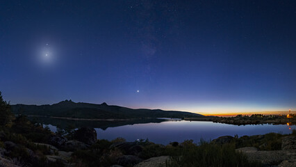 Colorful twilight with Crescent moon and planets Venus, Saturn, Jupiter and Milky Way over mountain...