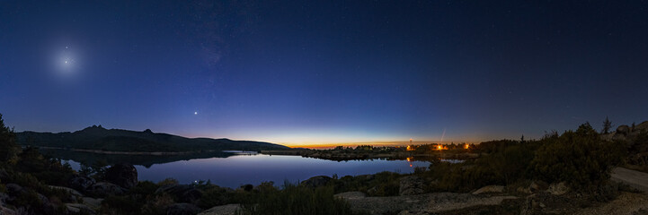 Panorama of nigh sky with Crescent moon and planets Venus, Saturn, Jupiter and Milky Way over lake,...