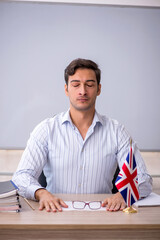 Young male english language teacher in the classroom