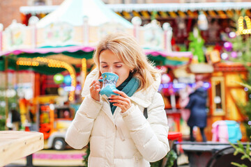 Young girl with drink on Christmas market in Wroclaw, Poland