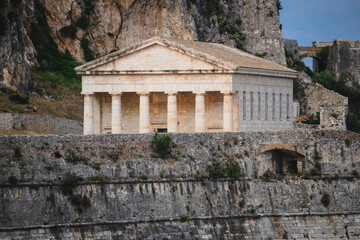 temple of apollo in delphi corfu greece with mountain behind